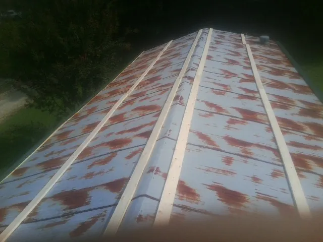 Rusted metal roof panels with new wood purlins before replacement — Storm Damage Roof Repair in Walpole by Roofing Brothers